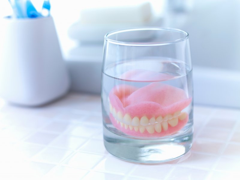 Dentures soak in glass