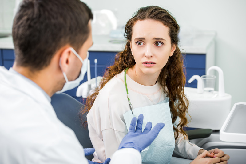 Patient talking to their dentist about gum disease